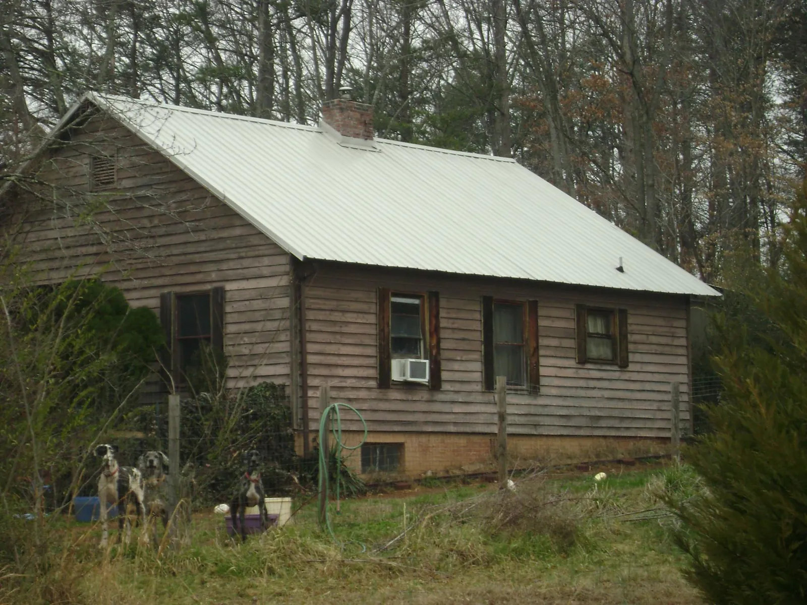White metal roof on an old wood sided farmhouse, from a Metal Roof Installation job in Brooklyn
